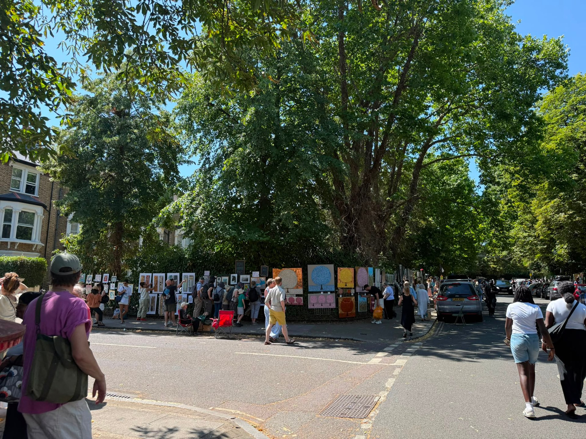 Visitors walking between artists' displays at Brixton Urban Art Fair